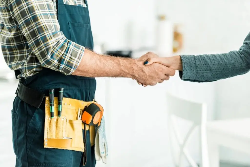 Service technician shaking hands with customer